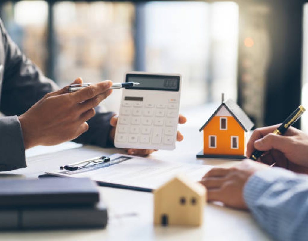 House model with agent and customer discussing for contract to buy, get insurance or loan real estate or property.